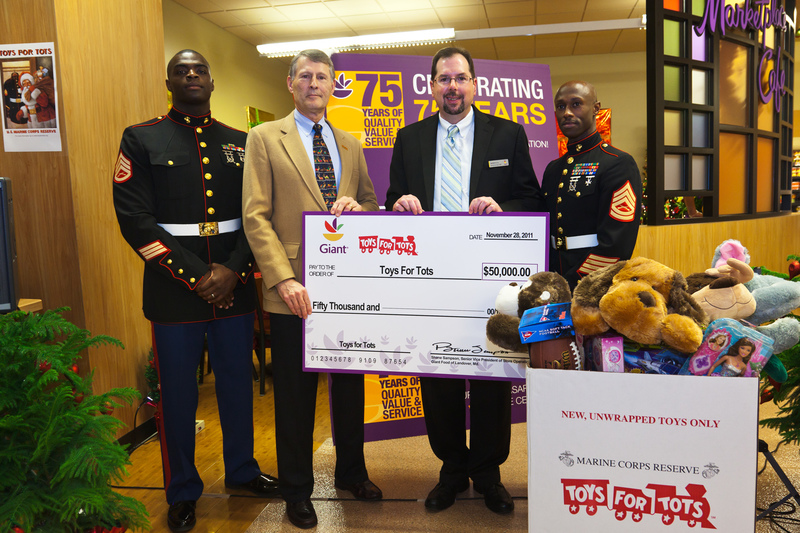 At the Giant Food check presentation to the Marine Toys for Tots Foundation are (l-r) Marine Staff Sgt. Eugene Sharpe; Bill Grein, vice president, Marine Toys for Tots Foundation; Jamie Miller, public and community relations manager, Giant Food of Landover, Md.; and Gunnery Sgt. James Sirmones, Washington, D.C. Toys for Tots coordinator. SOURCE SUBMITTED